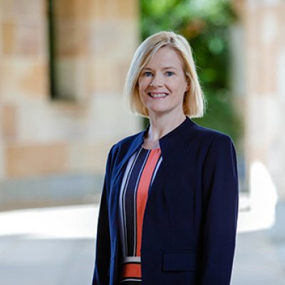 Professor Brenda Gannon from the waist up with UQ sandstone visible behind